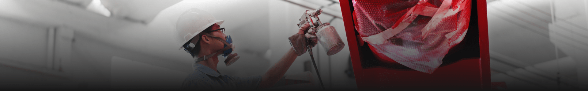 Paint spray gun worker painting a car